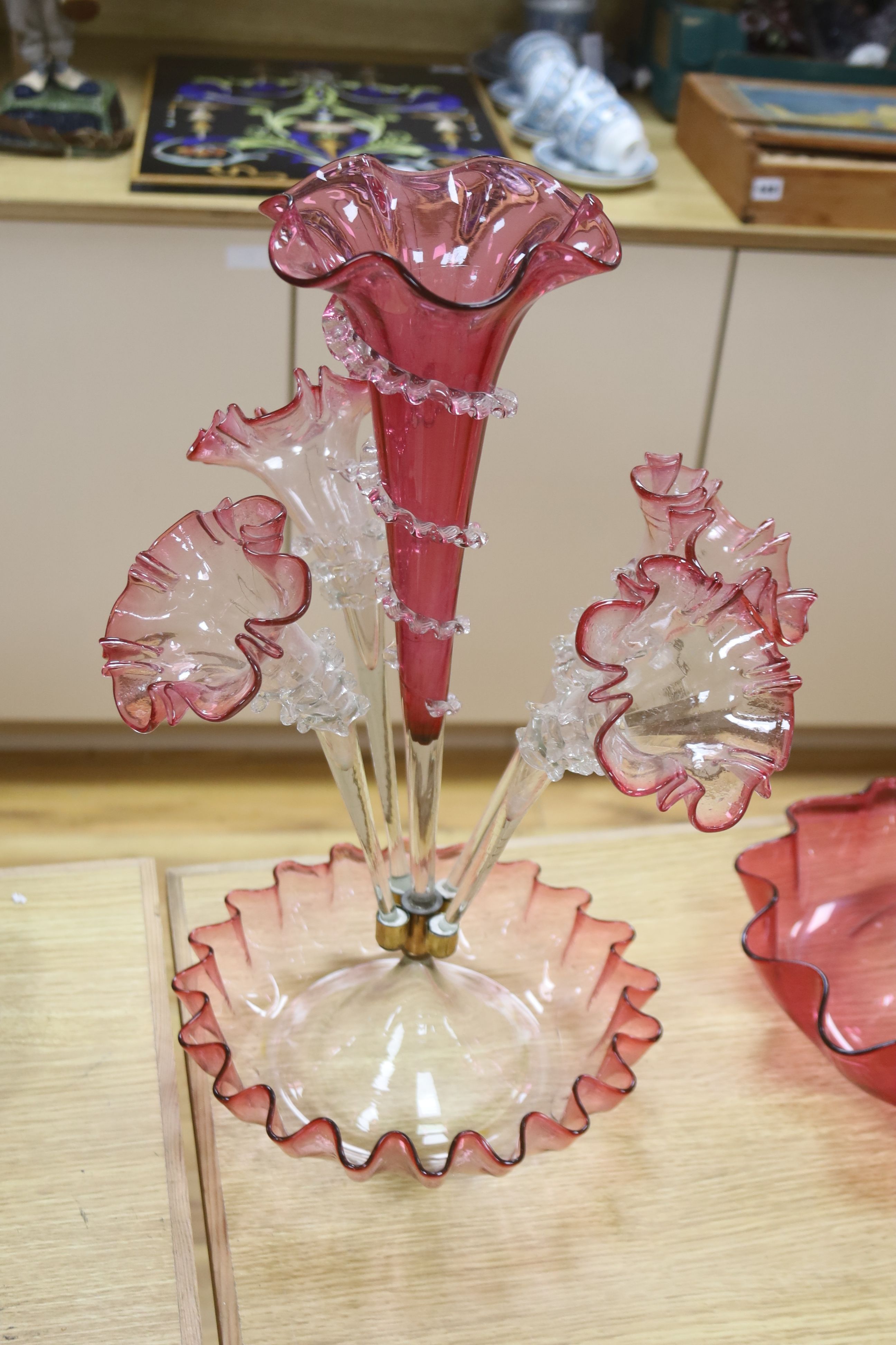 A Victorian cranberry glass four branch epergnes and a single glass epergne, tallest 47cm